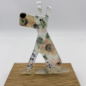 Sitting dog in cream flowers glass